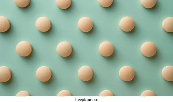 Close up of pattern of round pills on green background