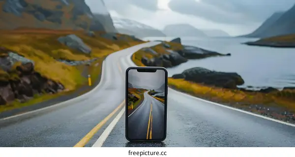 Smartphone on Road with Mountain and Water View