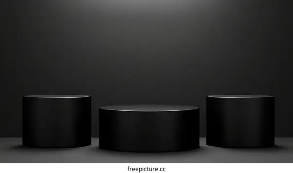 Three Black Cylindrical Pedestals on a Dark Background