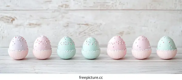 Pastel Easter Eggs on a White Wooden Background