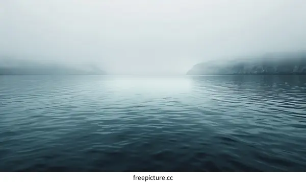 Misty fjord landscape with mountains in the distance