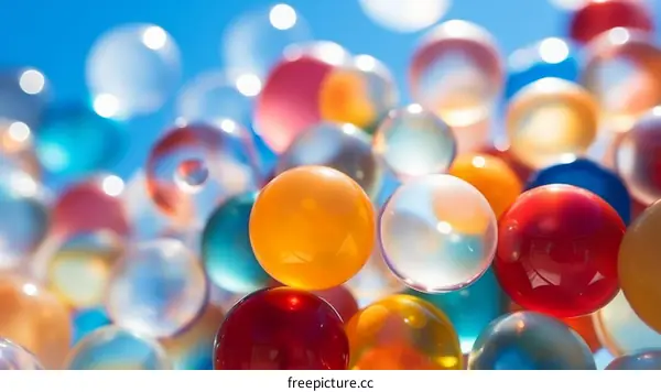Colorful translucent bouncy balls with a blue background