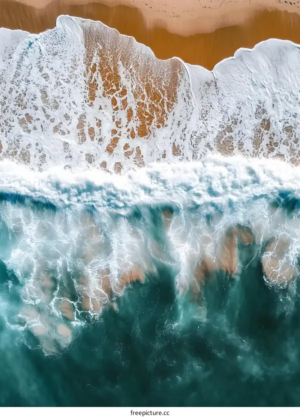 Aerial View of Waves Crashing on a Sandy Beach