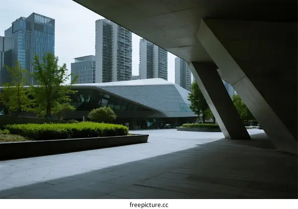 Modern architectural structure with urban skyscrapers in the background