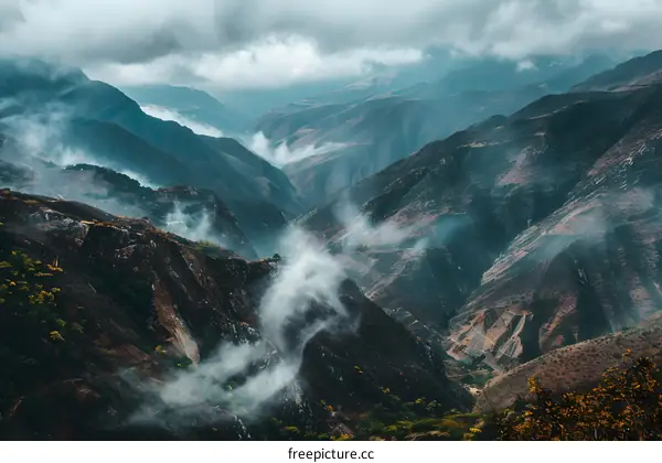 Mountain Range With Mist And Clouds