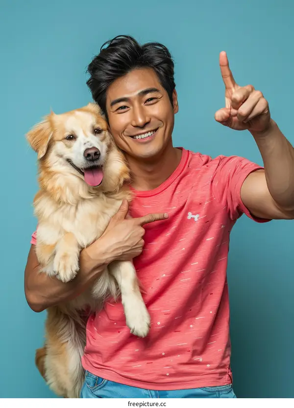Asian man smiling and pointing with his dog