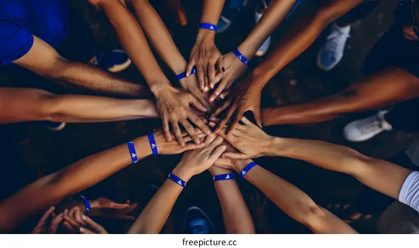 Diverse Hands Reaching Up Together In Unity