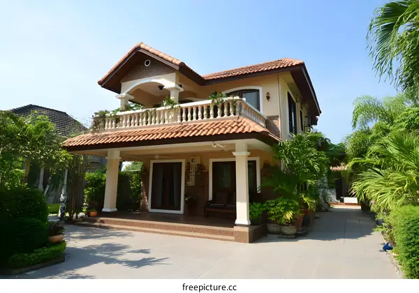 Two Story House With Balcony And Palm Trees