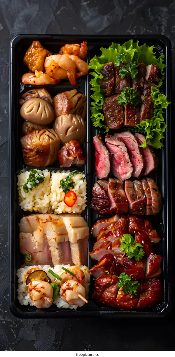 A variety of grilled meats and seafood in a black container