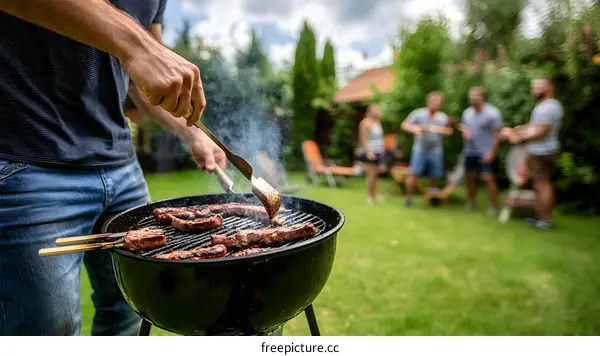 Man Grilling Meat On A Barbeque In Backyard With Friends
