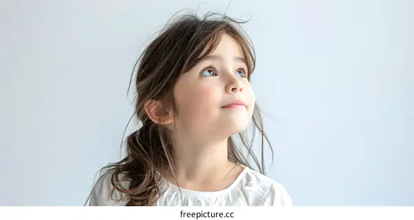 portrait of a cute little girl looking up