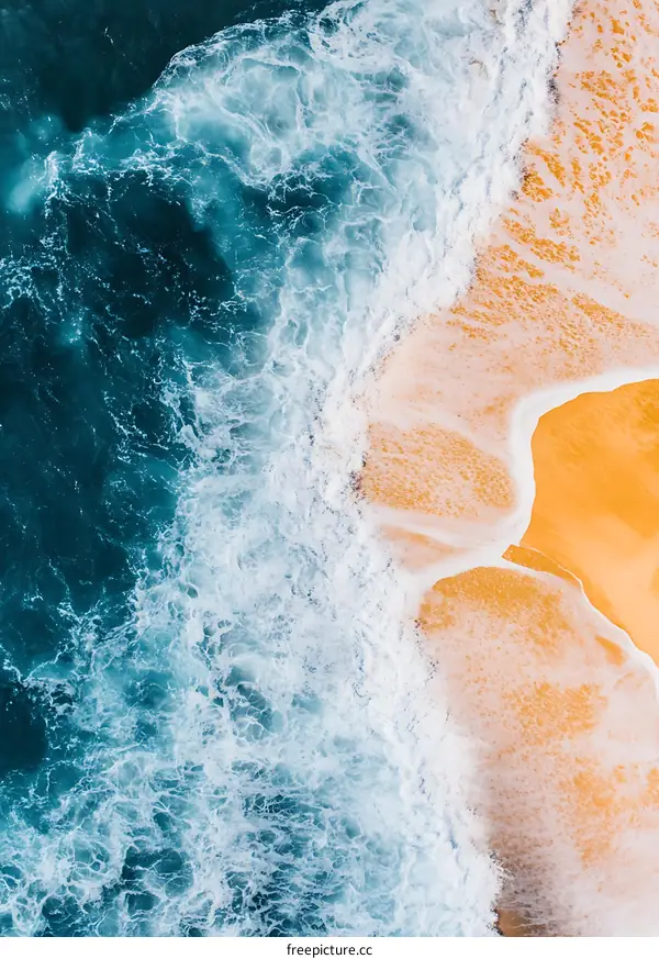 Aerial View of Ocean Waves Crashing on Sandy Beach