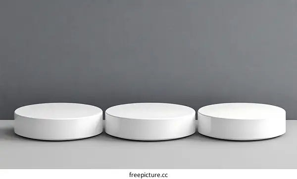 Three White Circular Platforms against a Gray Background