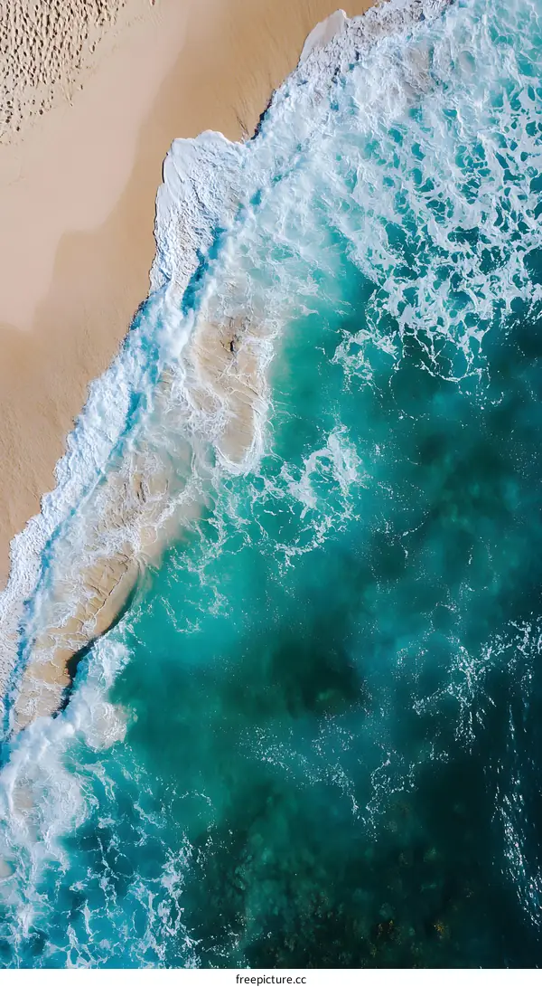 Aerial View of Turquoise Ocean Waves Crashing on Sandy Beach