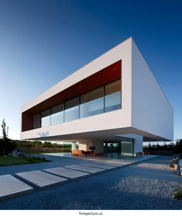Modern White House with Large Windows and Gravel Yard