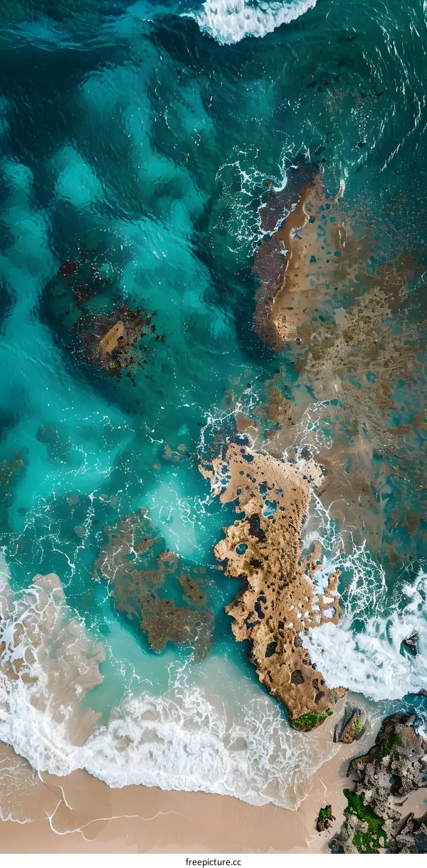 Aerial View of the Ocean Coastline with Waves Crashing on the Beach