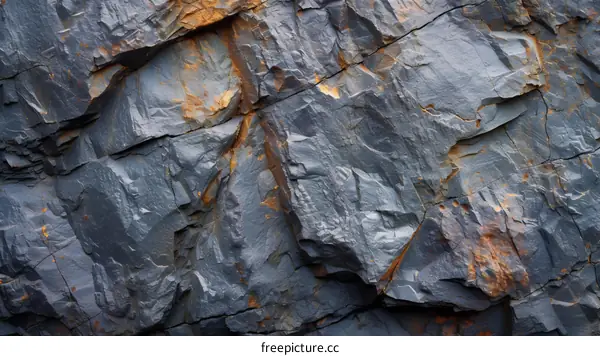 dark gray rock with rusty orange veins