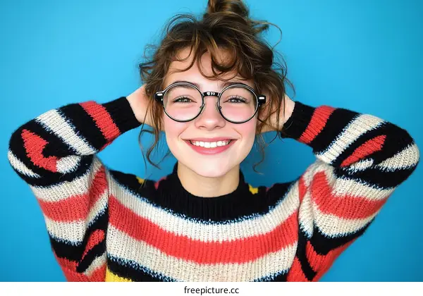 Smiling Teenager in a Colorful Striped Sweater