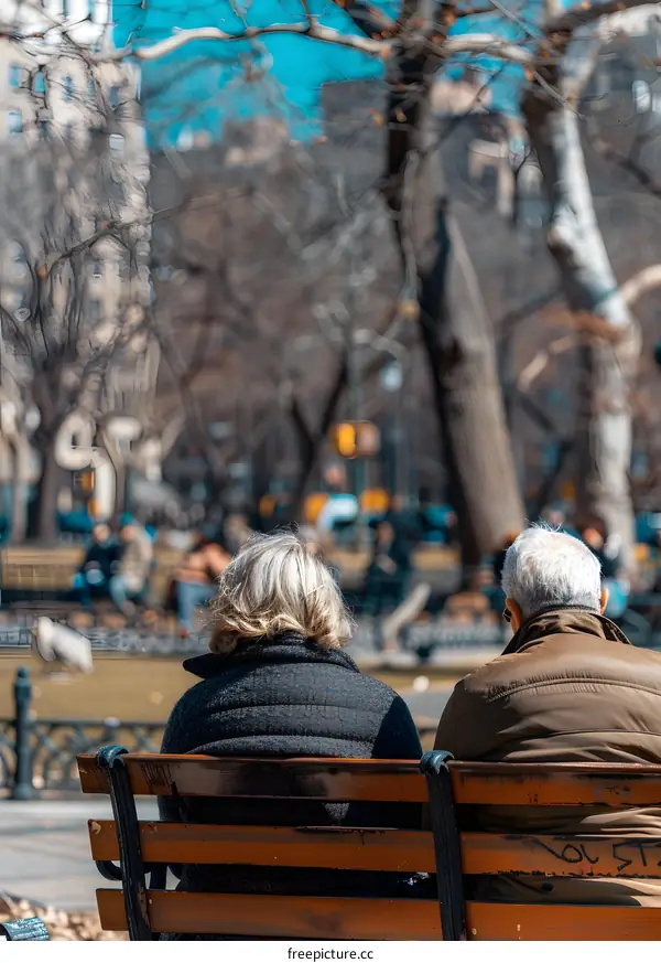 Couple Sitting on Bench in City Park