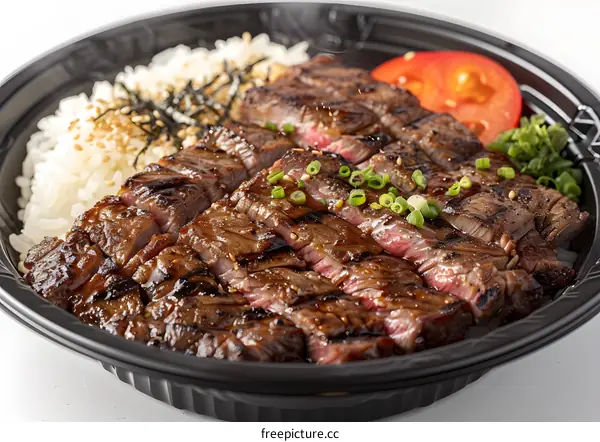 Close Up Of Grilled Steak With Rice, Tomato, And Green Onions In Black Take Out Container