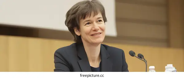 Smiling Woman Speaker at a Conference