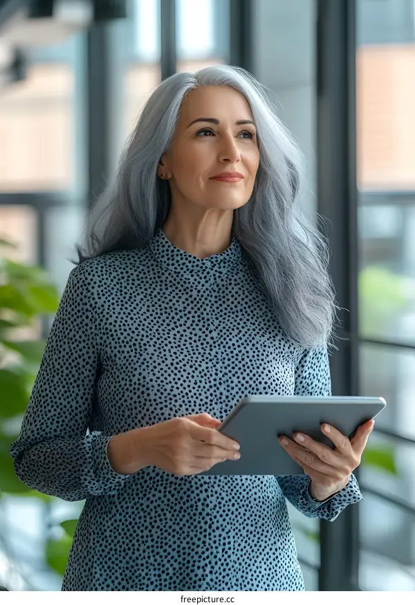 Smiling Senior Woman Using Tablet Near Window
