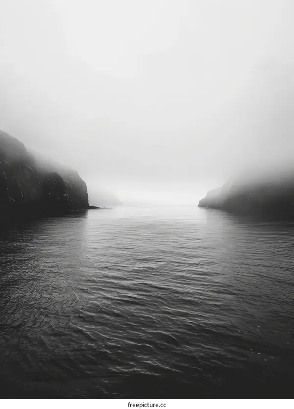 Black and white photo of a foggy fjord in Norway