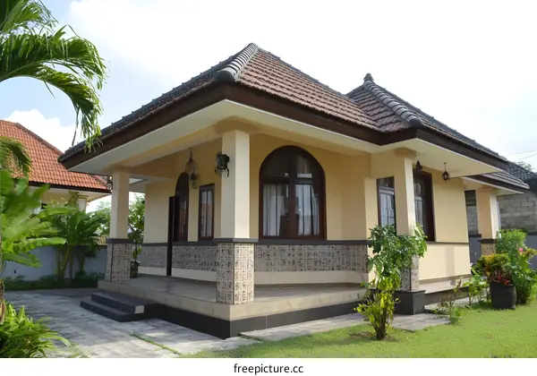 Exterior of a Tropical Style Home with Large Windows and Lush Green Landscaping