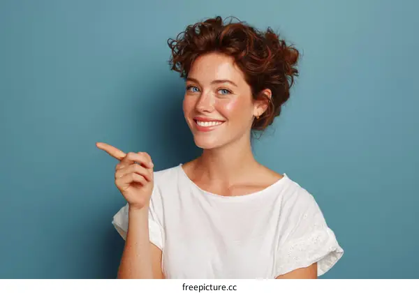 Smiling Woman Pointing, Studio Portrait