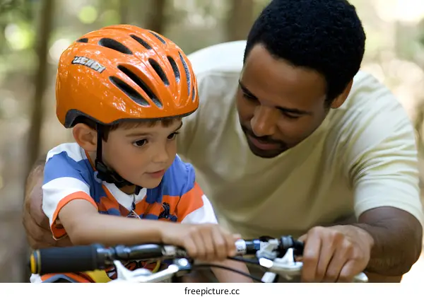 Father and Son Learning to Ride a Bicycle Together in a Forest Setting