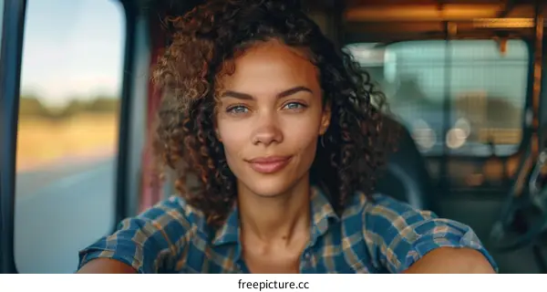 Portrait of a young woman with curly hair smiling