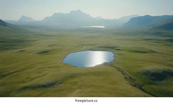 High-Altitude Expansive Meadow Landscape with a Serene Lake
