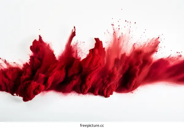 Red powder explosion on white background
