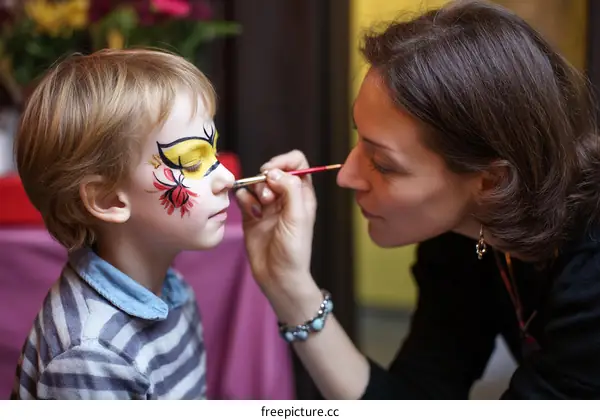 Face Painting Artist Applying Design to Childs Face