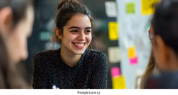 Smiling Young Woman in a Group Discussion