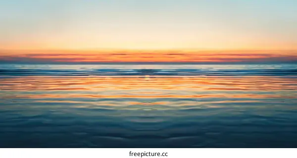 Serene Sunset with Mirror-like Ocean Reflection