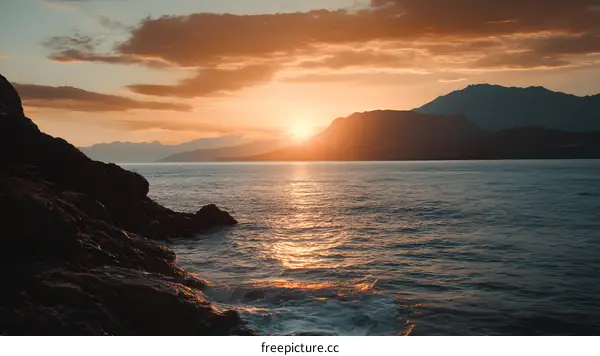 Sunset Over the Sea with Mountain Silhouette