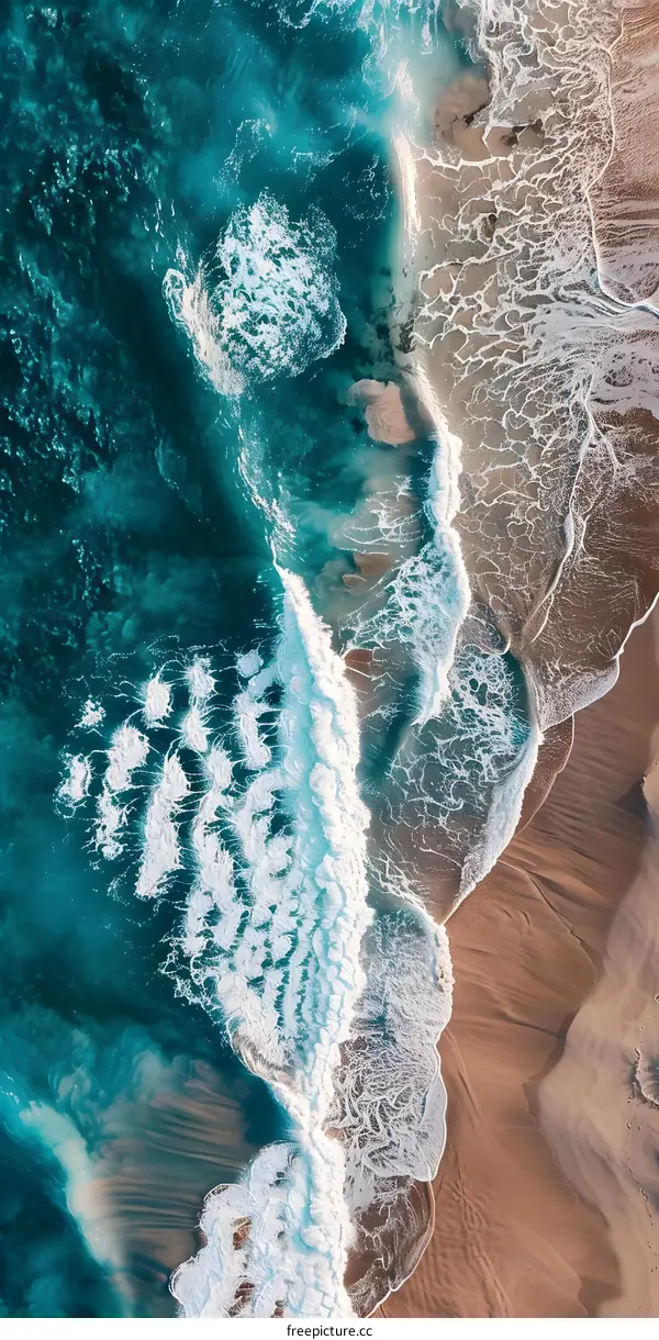 Aerial View of Ocean Waves Crashing on Sandy Beach