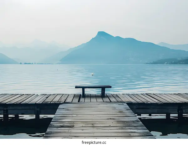 Wooden Dock Bench Overlooking Lake and Mountains