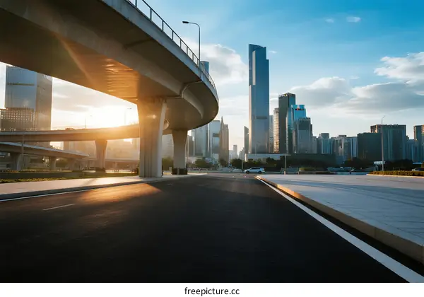 Modern city overpass with urban skyscrapers under sunny sky