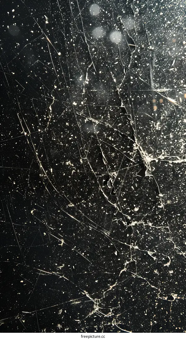 Black grunge texture with white scratches and dust