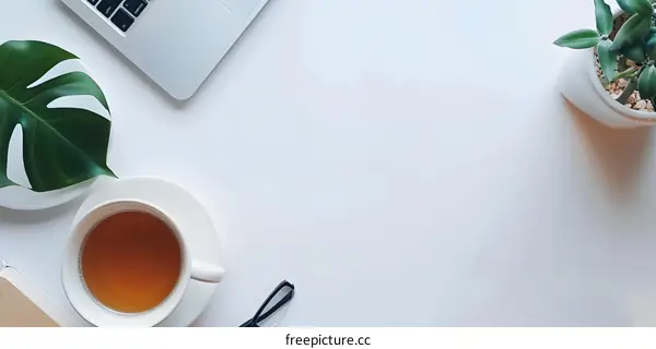 Minimalist Flat Lay with Tea, Laptop, and Plants
