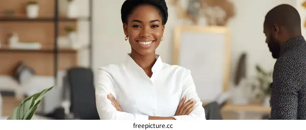 Smiling Businesswoman With Arms Crossed In Office Setting