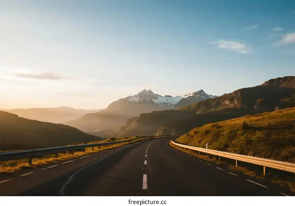 Scenic highway with mountains in the distance under clear sky