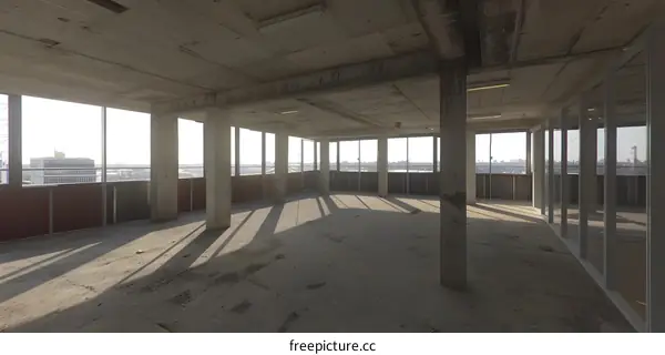 Empty Concrete Room with Windows and City View