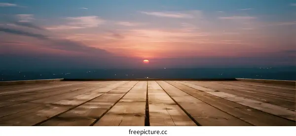 Beautiful sunset over an empty concrete platform at dusk