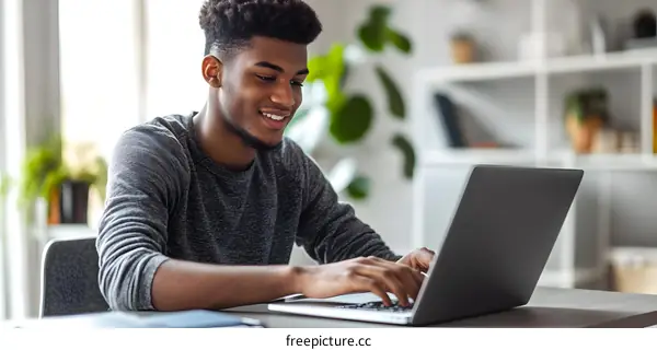 Smiling African American Man Working on Laptop