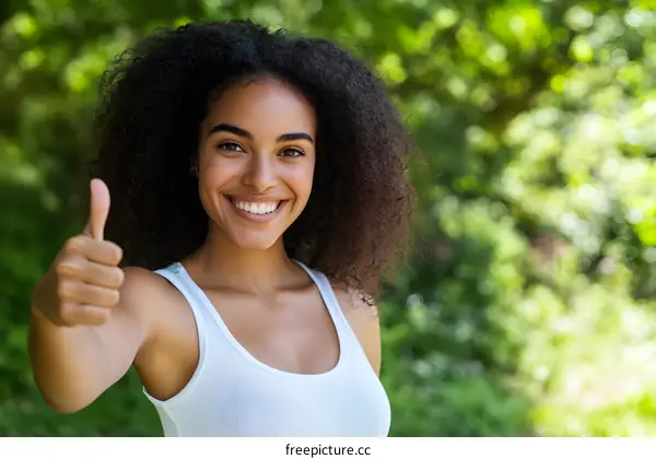 Happy Young Woman with Afro Hair Giving Thumbs Up