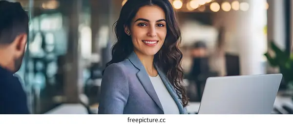 Smiling Woman In A Business Meeting With Laptop