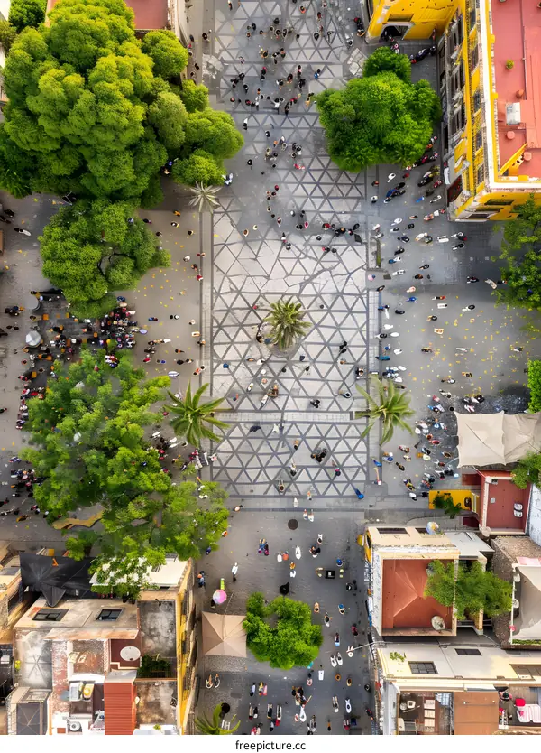 Aerial View of a Crowded Town Square with People and Buildings